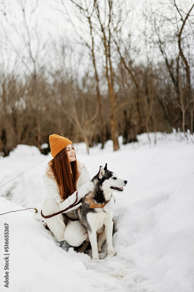 cheerful woman winter outdoors with a dog fun nature winter holidays