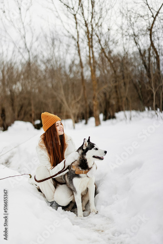 Fototapeta Naklejka Na Ścianę i Meble -  cheerful woman winter outdoors with a dog fun nature winter holidays