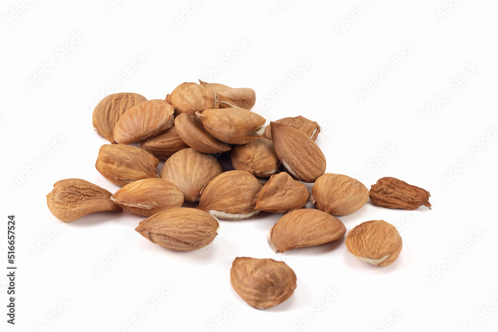 Peeled apricot kernels on bright background. Close up view. Peeled apricot kernels on bright background. Close up view.