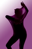 A female dancer poses covered with a velvet purple material