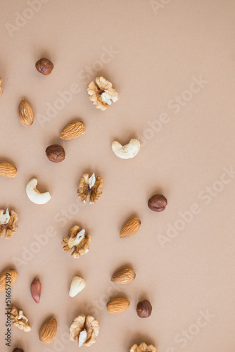 nuts mix for a healthy diet cashew, peanut, hazelnuts, walnuts, almonds on brown background