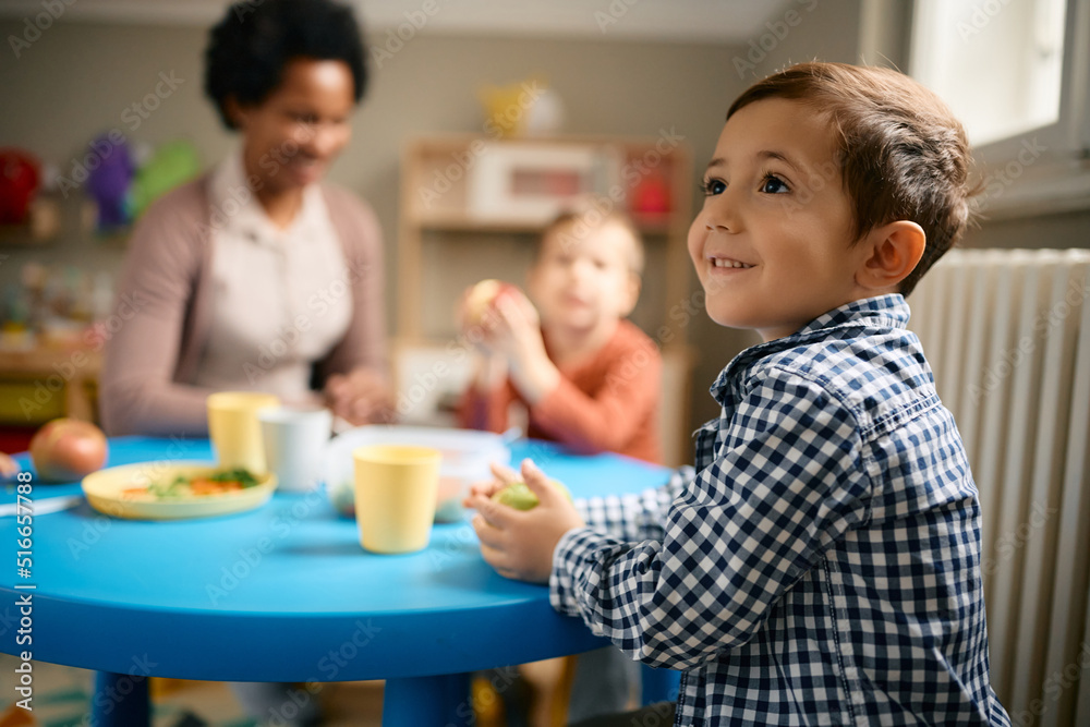 Happy small boy enjoys in lunch at kindergarten. Happy small boy enjoys in lunch at kindergarten.