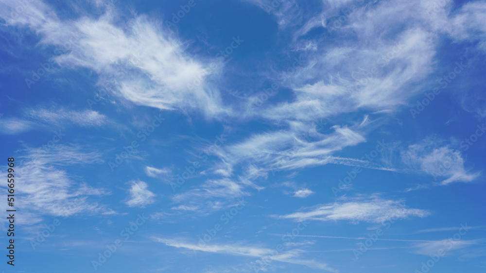 WIspy clouds and blue sky suitable for background use or sky substitution