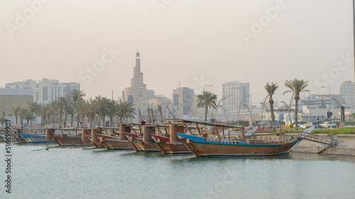 Doha, Qatar- Multiple wooden fishing dhows docked in the doha corniche.