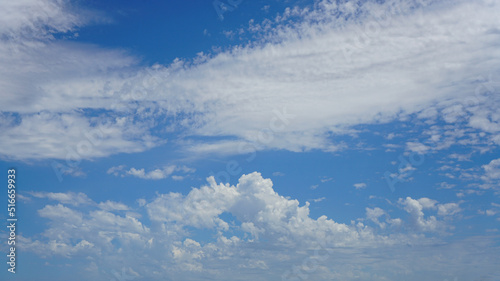 WIspy and cumulus clouds and blue sky for background use or sky substitution