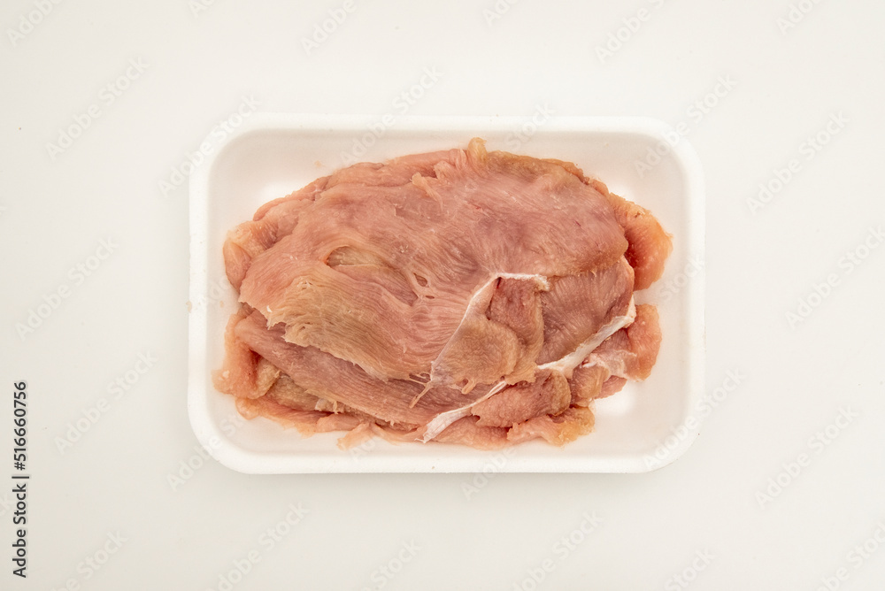 Package of fresh chicken breast fillets in a white styrofoam tray Package of fresh chicken breast fillets in a white styrofoam tray