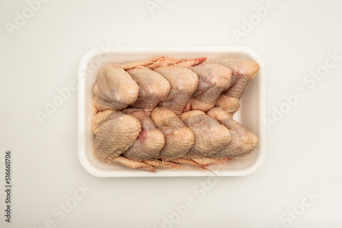 Fresh chicken wings inside a white polystyrene tray