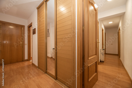 Tablou pe pânză Hallways of a residential home with fitted wardrobes with sliding wooden doors a