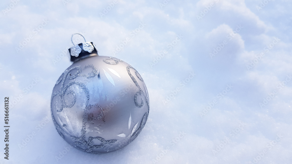 A Christmas tree toy in the form of a ball in shades very characteristic of the fashionable new year 2022. pantone color A Christmas tree toy in the form of a ball in shades very characteristic of the fashionable new year 2022. pantone color