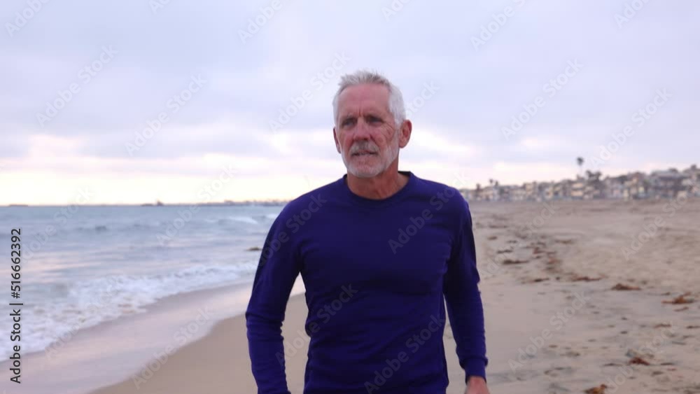 A mature 66 year old man jogging at the beach in Southern California. Slow Motion. A mature 66 year old man jogging at the beach in Southern California. Slow Motion.