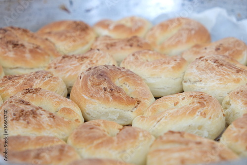 Close-up and some blurred freshly baked pastry with sesame in the oven. 