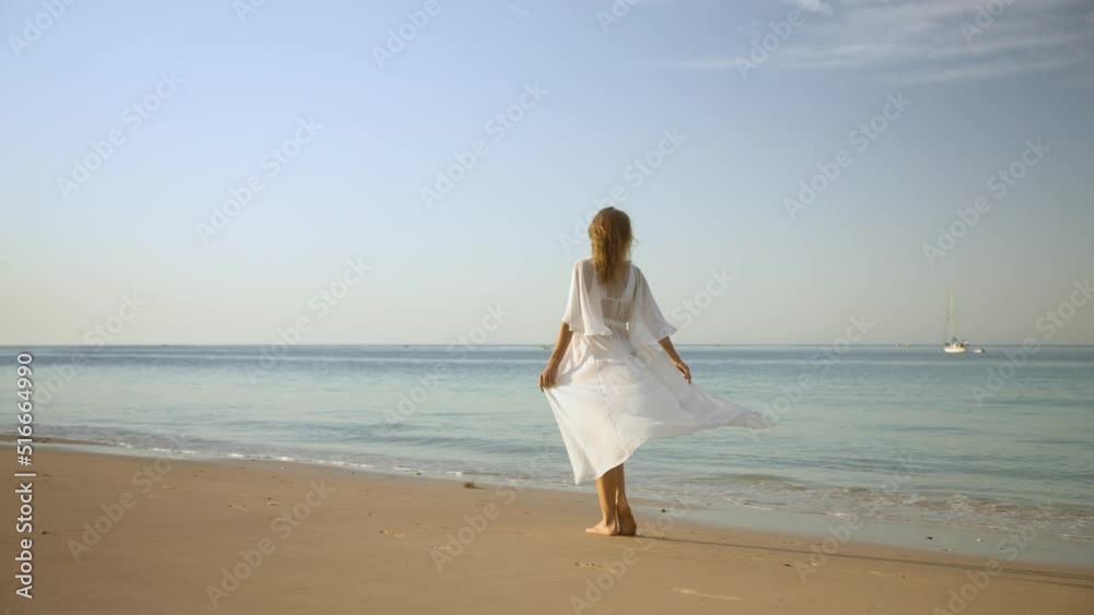 Woman walking on the beach at morning Woman walking on the beach at morning
