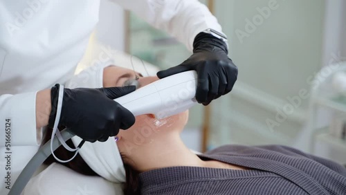 facelift by modern cosmetology treatments, beautician is using broadband light for rejuvenating