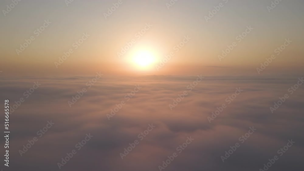 Aerial view from airplane window at high altitude of dense puffy cumulus clouds flying in evening Aerial view from airplane window at high altitude of dense puffy cumulus clouds flying in evening