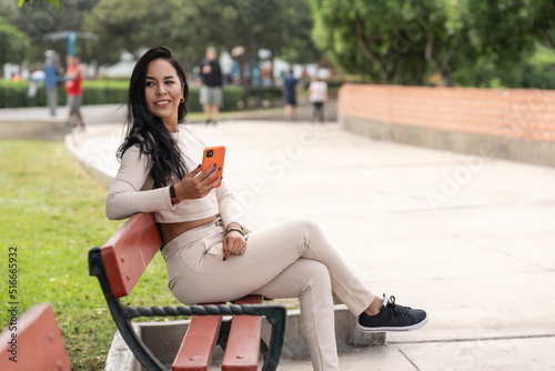 Woman looking aside while sitting on a bench outdoors