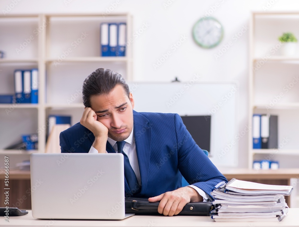 Young male businessman working in the office Young male businessman working in the office