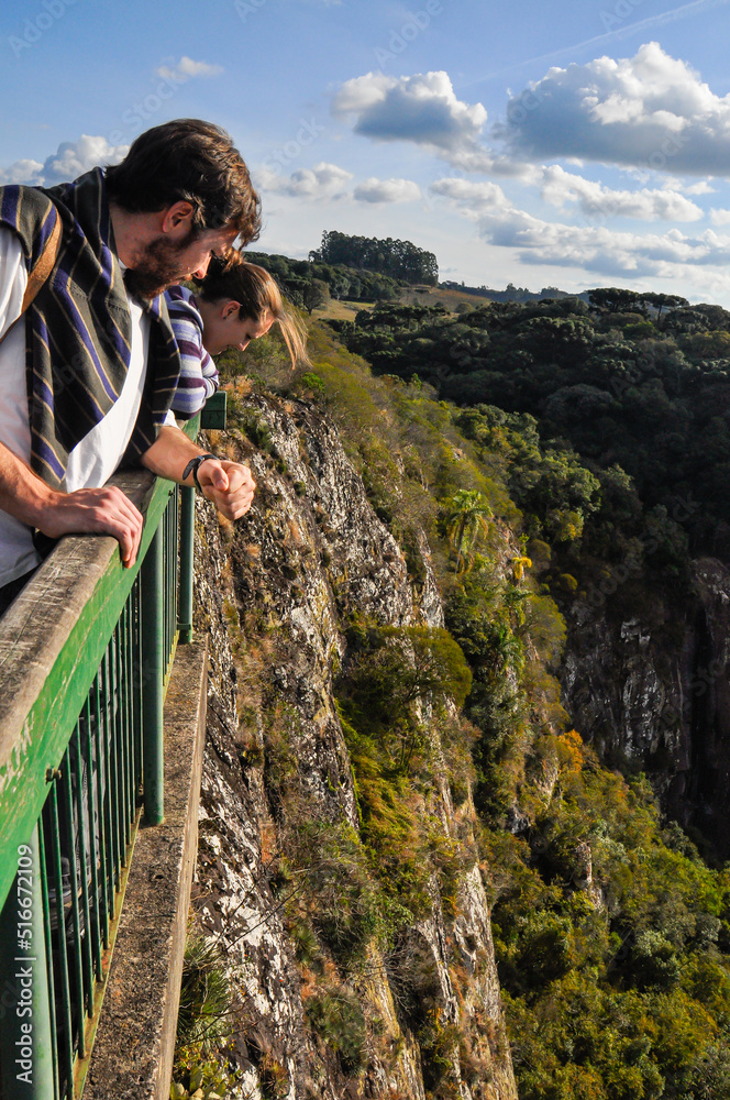 Naklejka premium People looking down from the cliffside platform at Gelain Lookout in Flores da Cunha, Rio Grande do Sul, Brazil