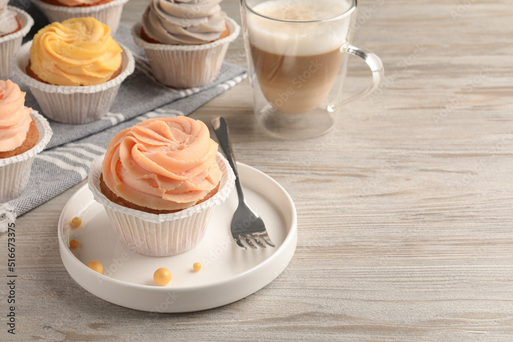Tasty cupcakes served on wooden table. Space for text Tasty cupcakes served on wooden table. Space for text