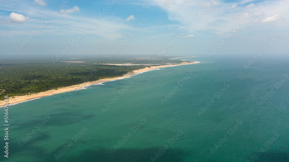 Tropical landscape with beautiful sandy beach and blue sea. Sri Lanka.