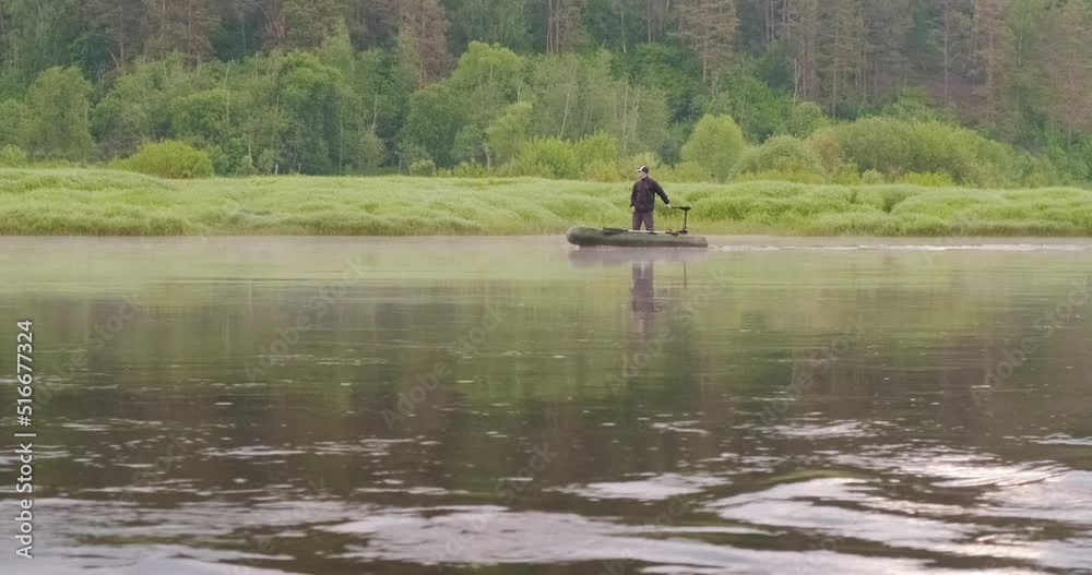 Beautiful summer morning landscape with a fisherman's boat sailing against the flow of the river in the wilderness, vacation travel concept Beautiful summer morning landscape with a fisherman's boat sailing against the flow of the river in the wilderness, vacation travel concept