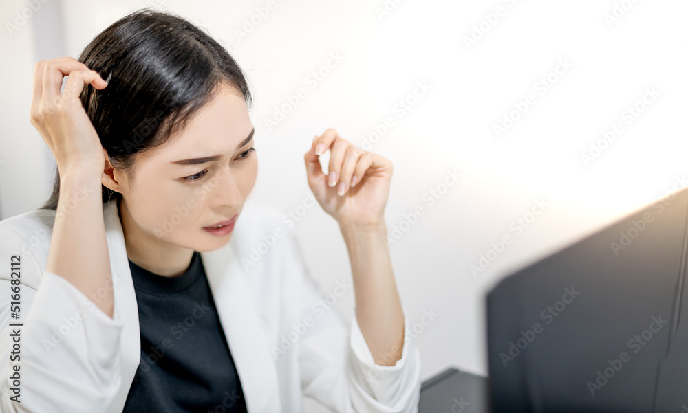 Asian young feeling stressed from work while sitting in front of a laptop in their home. Asian young feeling stressed from work while sitting in front of a laptop in their home.