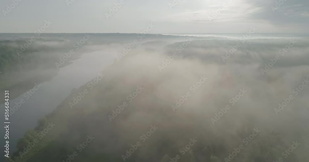 Aerial view of sunrise over misty morning forest and river flight. Summer forest early in the morning. Forest wood fog nauture wild mist aerial. Aerial view of sunrise over misty morning forest and river flight. Summer forest early in the morning. Forest wood fog nauture wild mist aerial.