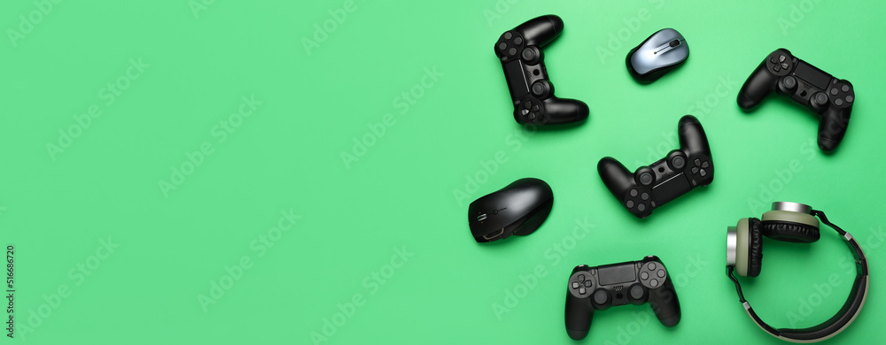 Modern gaming accessories on green background with space for text Modern gaming accessories on green background with space for text