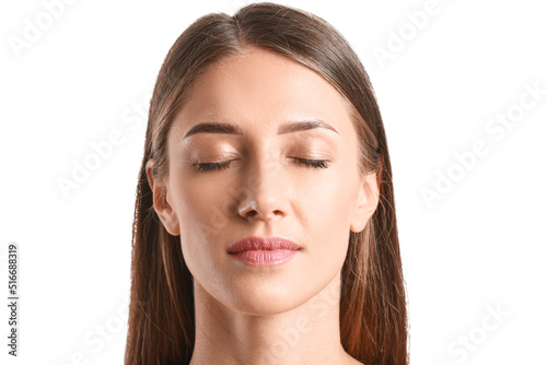 Young tanned woman on white...