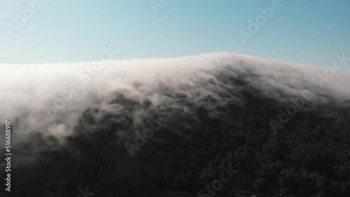 aerial moves to an amazing lenticular cloud formation blanketing the mountain of Monte de Santa Tecla (Santa Tecla Mount) Galicia, Spain photo