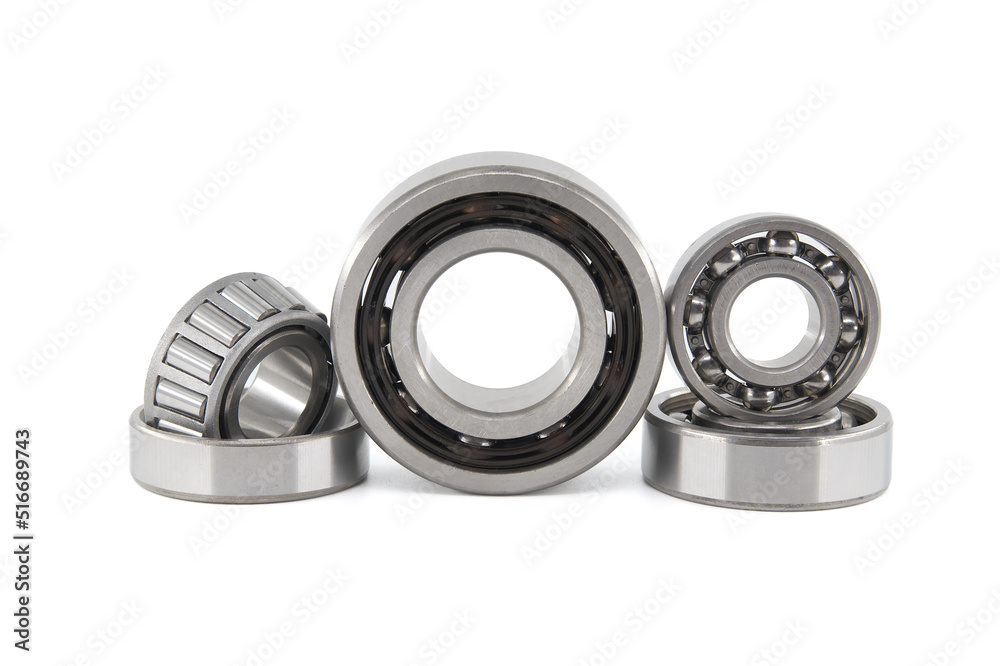 Group of various ball and roller bearings on white Group of various ball and roller bearings on white