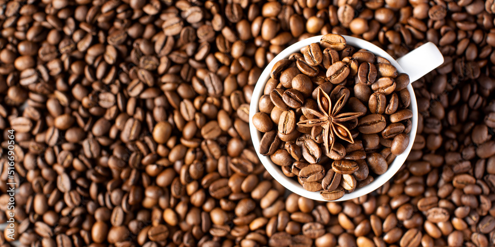 Roasted coffee beans and star anise in a mug on a background of coffee beans. Roasted coffee beans and star anise in a mug on a background of coffee beans.