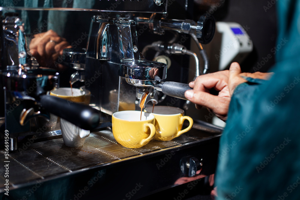 Making two cups of espresso with a coffee machine. Making two cups of espresso with a coffee machine.