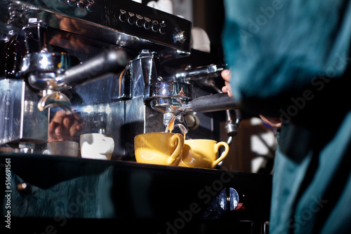 Making two cups of espresso with a coffee machine.