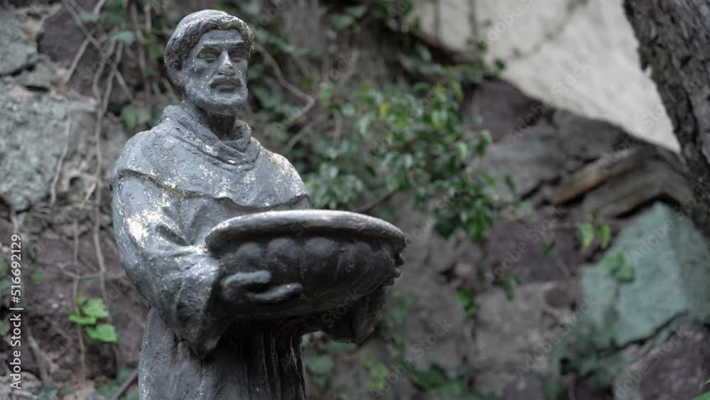 Close up of a sculpture of a man holding a basket Close up of a sculpture of a man holding a basket