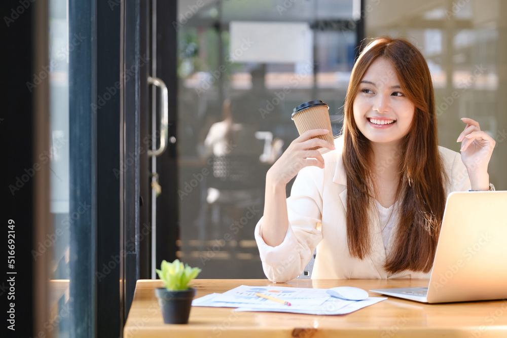 Happy businesswoman relaxing at office desk
