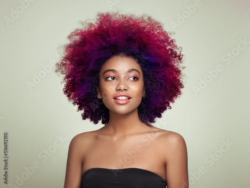 Beauty portrait of African American girl with colorful dyed afro hair. Beautiful black woman. Cosmetics, makeup and fashion