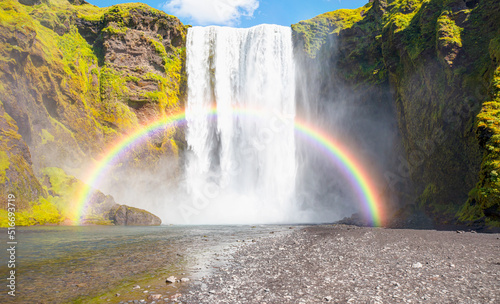 Icelandic Landscape concept - View of famous Skogafoss waterfall and amazing rainbow