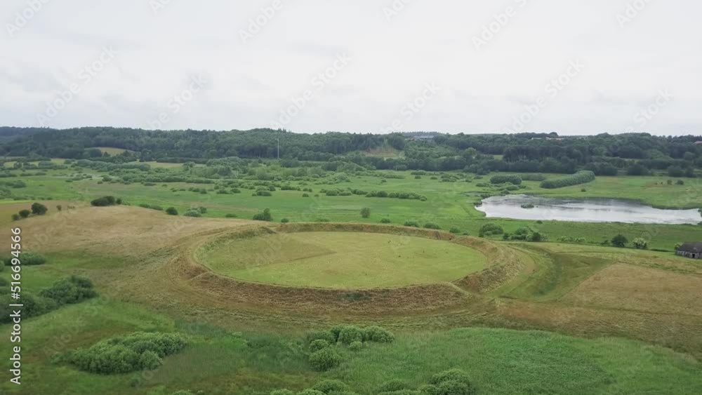 Drone View Of Famous Viking Castle Fyrkat, A Former Viking Ring Castle In Hobro, Denmark. aerial ascend Drone View Of Famous Viking Castle Fyrkat, A Former Viking Ring Castle In Hobro, Denmark. aerial ascend