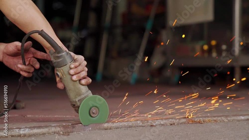 Close up of Electric grinding wheel smooths steel and iron. Spark from hot metal. Slow Motion 120 fps.