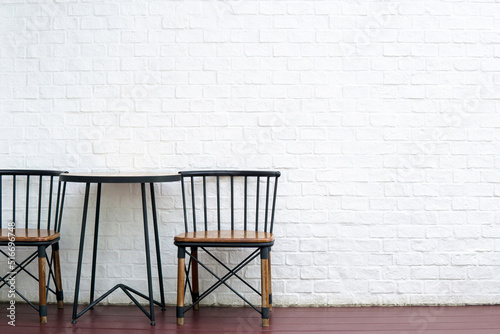 White Brick Wall And Wooden Table And Chairs For Background