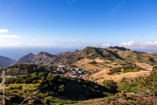 Scenic view from the lookout point Mirador de Jardina on a mountain village near San Cristobal de La Laguna, northeastern Tenerife, Canary Islands, Spain, Europe, EU. Lush green hills. Atlantic Ocean