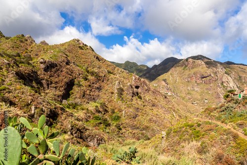 Panoramic view on the mountains of Anaga massif between Afur and Taganana on Tenerife, Canary Islands, Spain, Europe, EU. Hill landscape in UNESCO Anaga biosphere rural park. Clouds emerging. Hiking