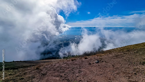 Panoramic view from volcano Mount Vesuvius on the bay of Naples, Province of Naples, Campania region, Italy, Europe, EU. Looking at the island of Capri and Mediterranean coastline on a cloudy day.