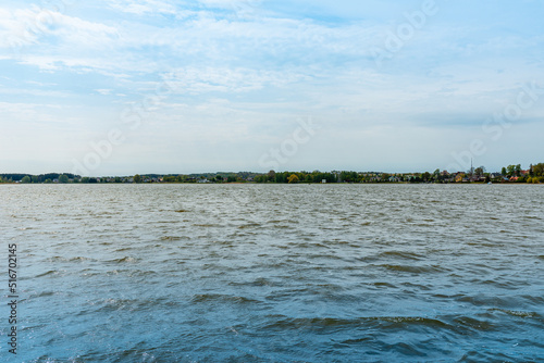 Beautiful summer panorama of Lithuania city Telsiai with cloudy sky, View over the lake Mastis to the city.