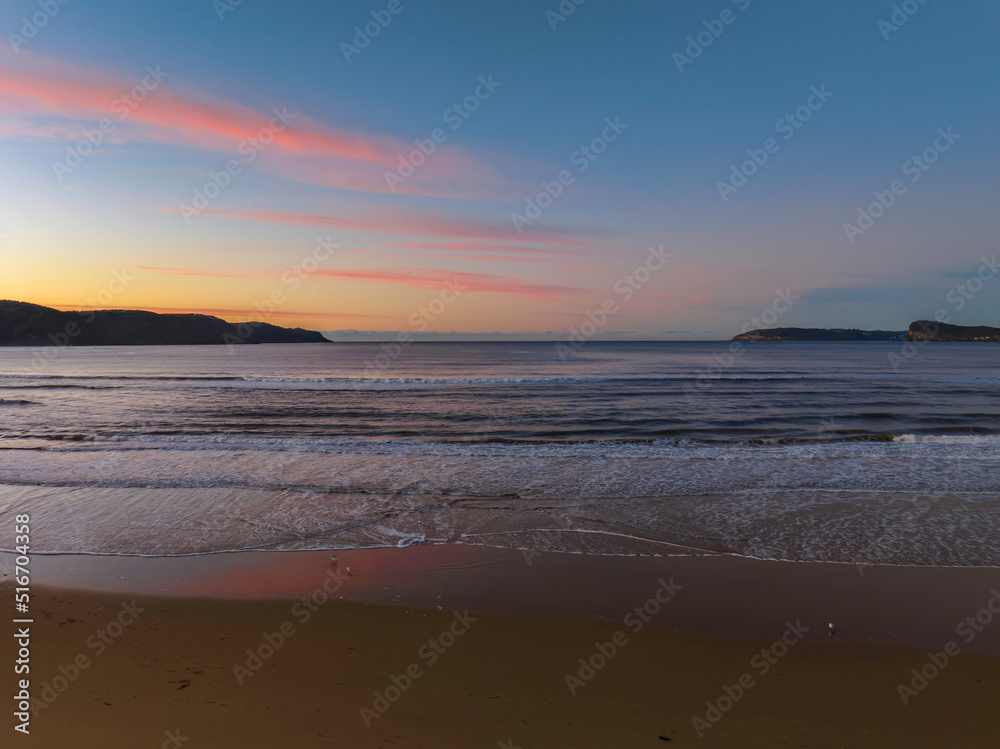 Gentle sunrise seascape with light scattered high cloud
