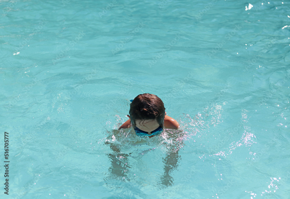 Boy enjoying in a swimming pool