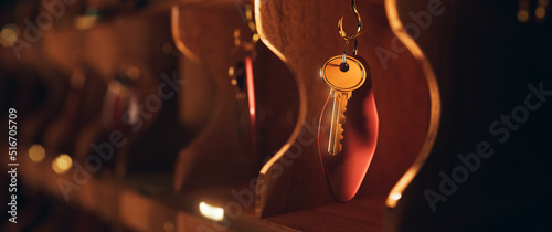 3D rendering, illustration of a hotel key hanging on a vintage cabinet or rack.