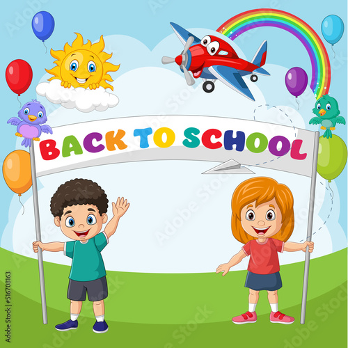 Back to school. Happy children holding a banner
