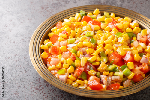 Sweet Corn Chat or Steamed yellow sweet corn, Chat Masala on a plate closeup in the table. Horizontal