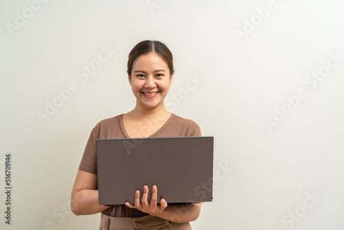 Asian women holding laptop computer. Work from home business concept.